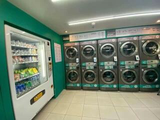 Interior view of a laundromat with washing machines and a vending machine