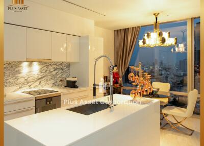 Modern kitchen with white cabinets, marble backsplash, and island