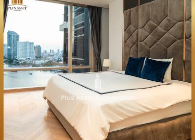 Modern bedroom with a large bed, a view of the city, and stylish decor