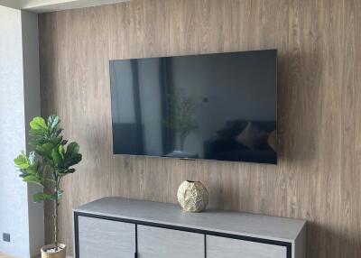 Modern living room with wooden wall paneling and mounted television