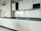 Modern minimalist kitchen with white cabinetry and sleek design