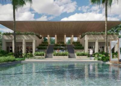 Luxurious outdoor swimming pool with lounging area and villa facade