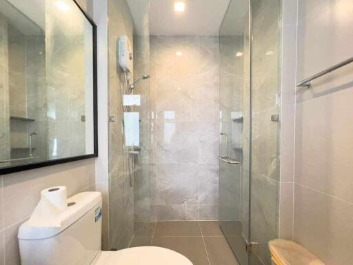 Modern bathroom with walk-in shower and neutral tiles
