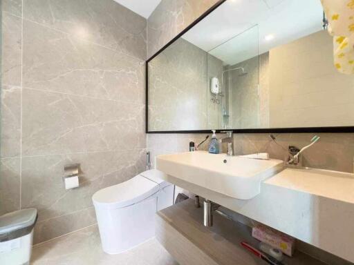 Modern bathroom interior with wall-mounted toilet and sink