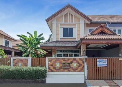 Modern two-story family house with terracotta roof tiles and front gate