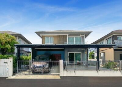 Modern residential home with carport and clean landscaping