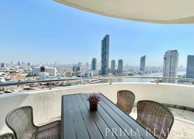 Spacious balcony with outdoor furniture and panoramic city skyline view