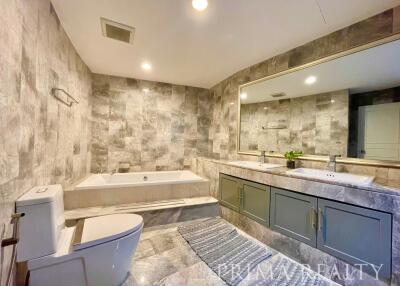 Spacious modern bathroom with a large tub and double vanity