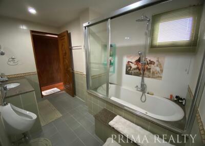 Spacious bathroom with modern fixtures and large bathtub