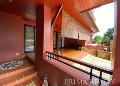 Spacious balcony with terracotta tiles and forest view