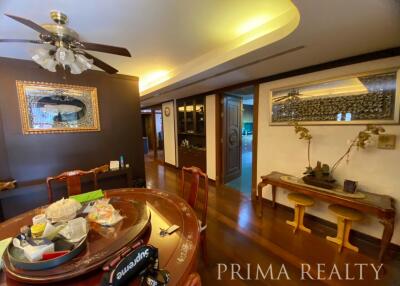 Spacious dining room with wooden furniture and decorative lighting