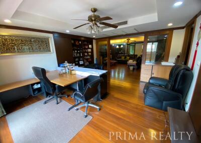 Spacious home office with wooden flooring and ceiling fan