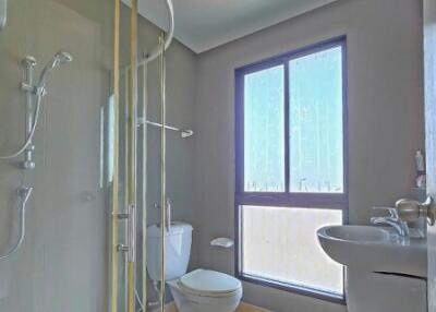 Modern bathroom with glass shower enclosure and natural light