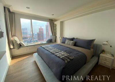 Elegant bedroom with large windows and city view