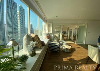 Modern sunlit living space with city skyline views