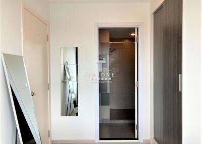 Modern entryway with a view into a sleek bathroom