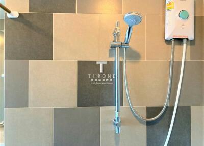 Modern bathroom with grey tiles and shower system