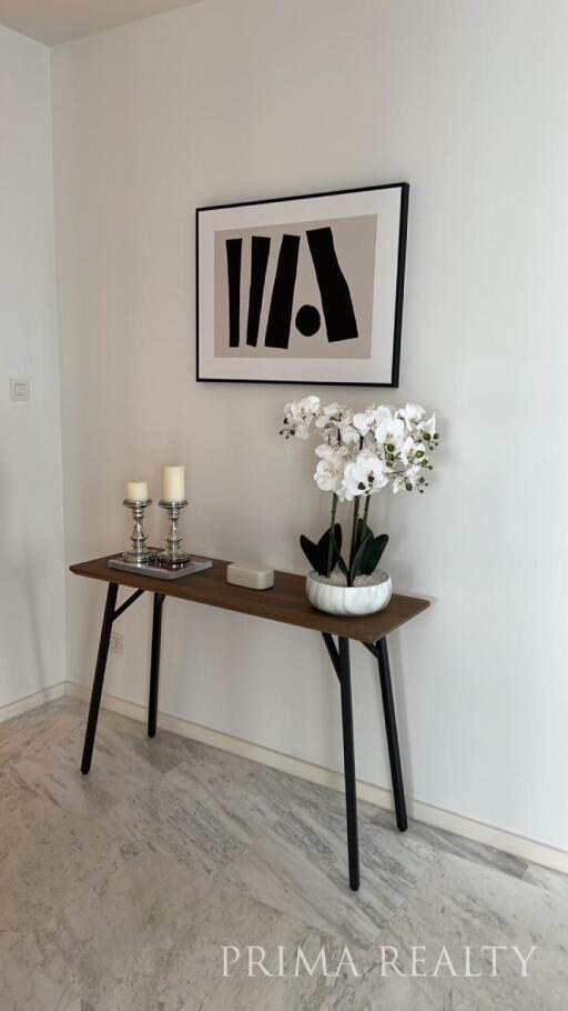 Elegant console table with decorative items and artwork in a modern living space