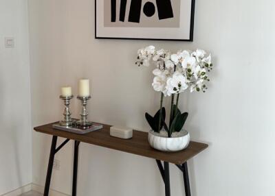 Elegant console table with decorative items and artwork in a modern living space