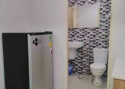 Compact bathroom with black and white tiles viewed from outside