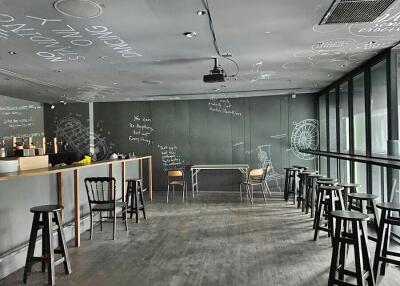 Modern bar area with chalkboard walls and stylish high stools