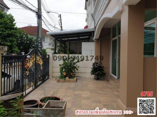 Front view of a house with a carport and gated fence