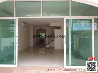 Exterior view of a building entrance with glass doors and tiled flooring