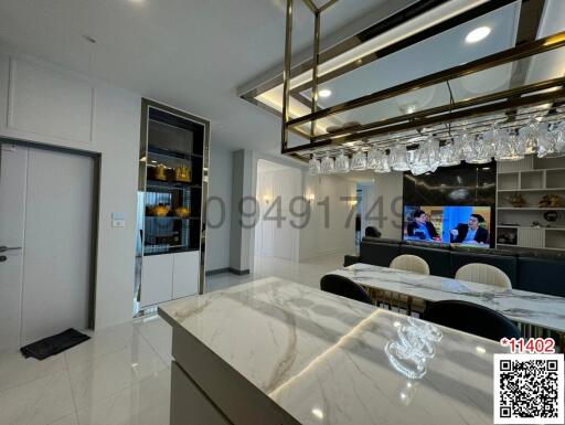 Modern kitchen with a wine refrigerator and elegant hanging lighting
