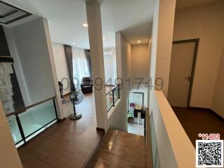 Spacious interior view of a home showing a living area and entrance hallway