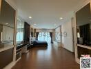 Spacious bedroom with wooden floor and integrated wardrobes