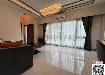 Elegant living room with polished floor and modern chandelier