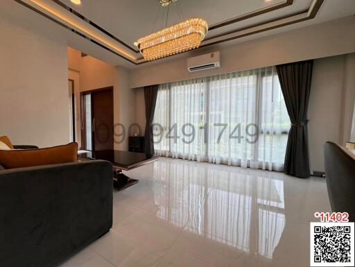 Elegant living room with polished floor and modern chandelier