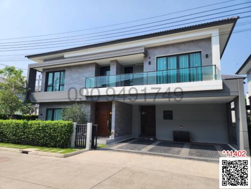 Modern two-story house with balcony and garage