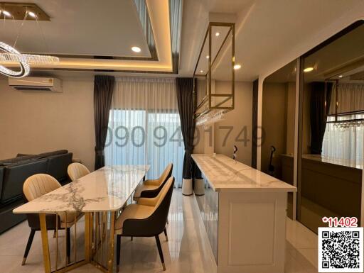 Modern living and dining room with elegant furniture and decor