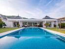 Luxurious house with pool and patio under clear sky