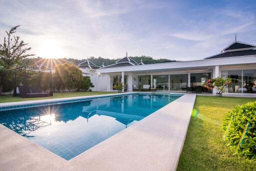 Luxury house with a swimming pool at sunset