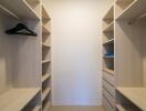 Spacious walk-in closet with custom shelving and ample storage space