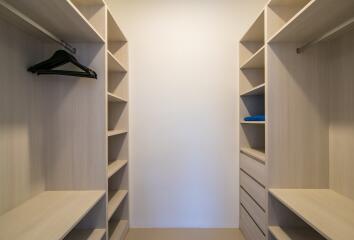 Spacious walk-in closet with custom shelving and ample storage space