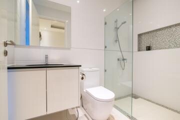 Modern white bathroom with glass shower and vanity