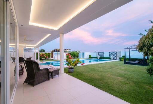 Luxurious poolside area with an expansive view at dusk