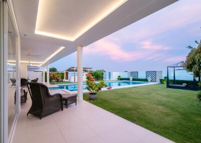 Luxurious poolside area with an expansive view at dusk