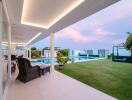 Luxurious poolside area with an expansive view at dusk