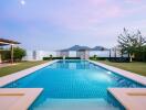 Luxurious outdoor swimming pool with mountain view at twilight