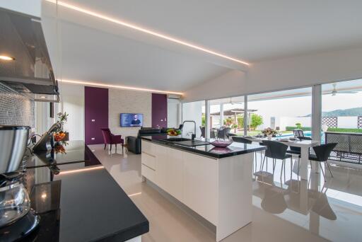 Modern spacious kitchen with adjacent dining area and scenic view