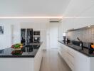 Modern kitchen with white cabinetry and stainless steel appliances