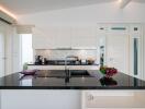 Modern kitchen with black countertops and white cabinetry