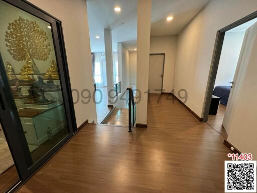 Spacious interior view of a well-lit room with wooden flooring and modern decor