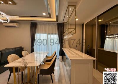 Modern living and dining room area with elegant furniture and ample lighting