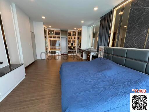 Modern bedroom interior with blue bedding and wooden floor