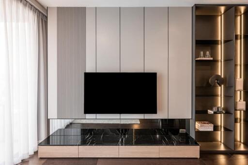 Modern living room with wall-mounted TV and shelving unit